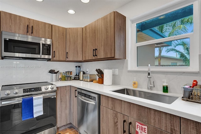 2320 SW 36th Ave, Fort Lauderdale, FL 33312 - kitchen with a sink, light countertops, backsplash, and stainless steel appliances