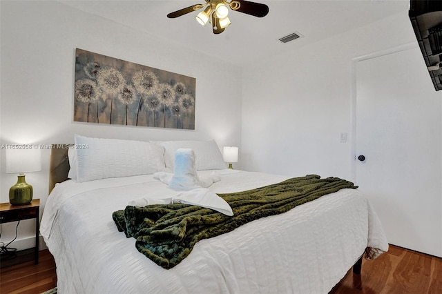 bedroom with ceiling fan and dark hardwood / wood-style floors