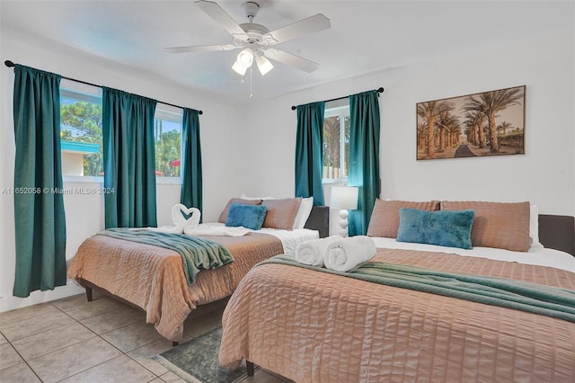 tiled bedroom featuring ceiling fan