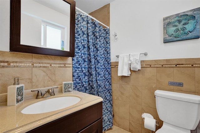 bathroom with tile walls, walk in shower, toilet, and vanity