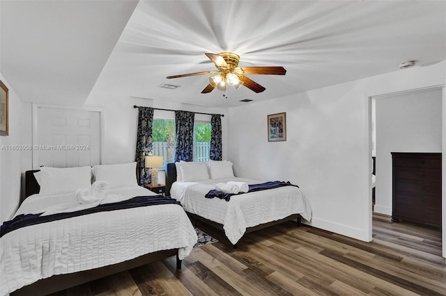 bedroom with dark wood-type flooring and ceiling fan