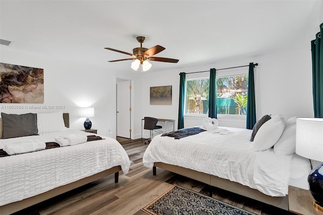 bedroom with hardwood / wood-style floors and ceiling fan