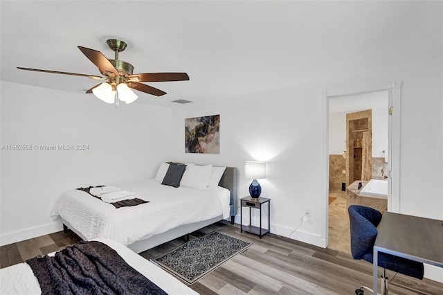 bedroom featuring ceiling fan, wood-type flooring, and ensuite bath