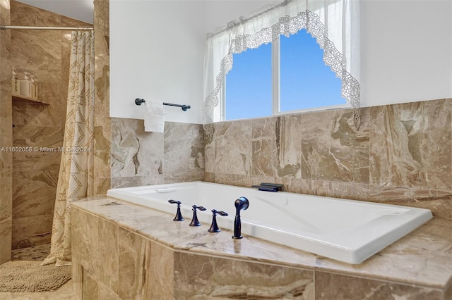 bathroom with tile walls and plus walk in shower