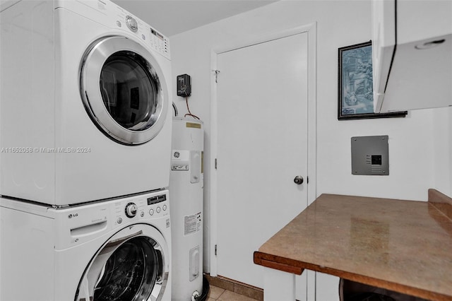 2320 SW 36th Ave, Fort Lauderdale, FL 33312 - laundry area featuring stacked washer and clothes dryer, light tile patterned flooring, laundry area, and water heater