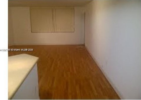 spare room featuring hardwood / wood-style floors