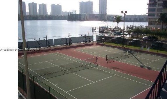 view of sport court with a water view