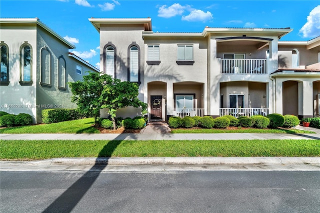 view of front of house featuring a balcony