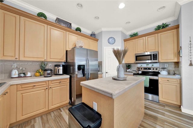 kitchen with ornamental molding, tasteful backsplash, a kitchen island, appliances with stainless steel finishes, and light brown cabinetry