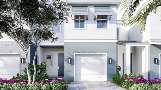 view of front of property with an attached garage and decorative driveway