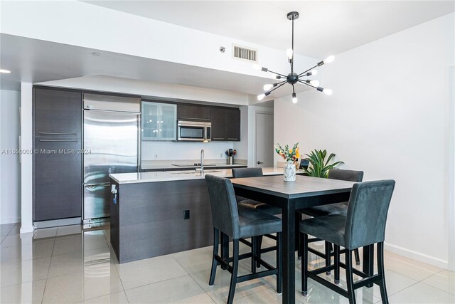 dining space with light tile patterned floors and a notable chandelier