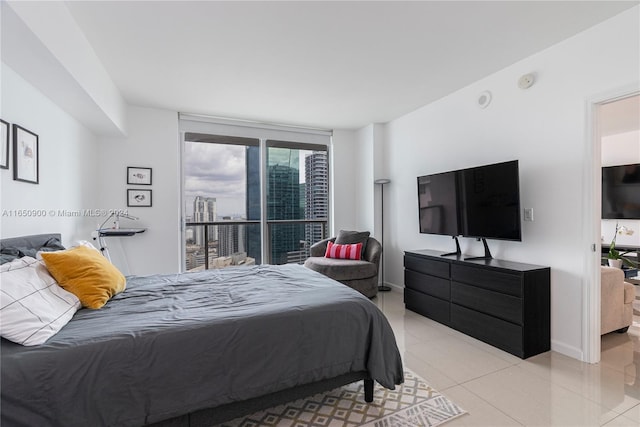 bedroom with tile patterned flooring and baseboards