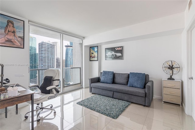 home office featuring light tile patterned floors, floor to ceiling windows, and baseboards