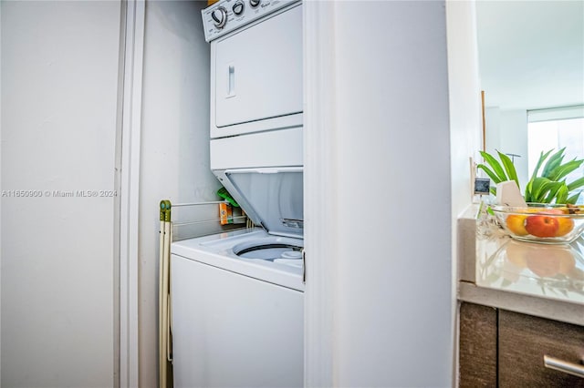 laundry room with laundry area and stacked washer and clothes dryer