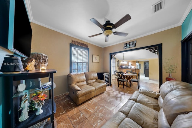 living room featuring ceiling fan and ornamental molding