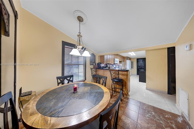 dining room with vaulted ceiling