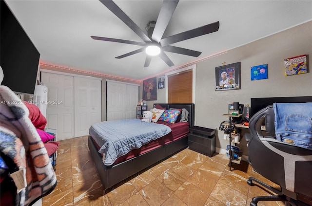 bedroom with ceiling fan and multiple closets