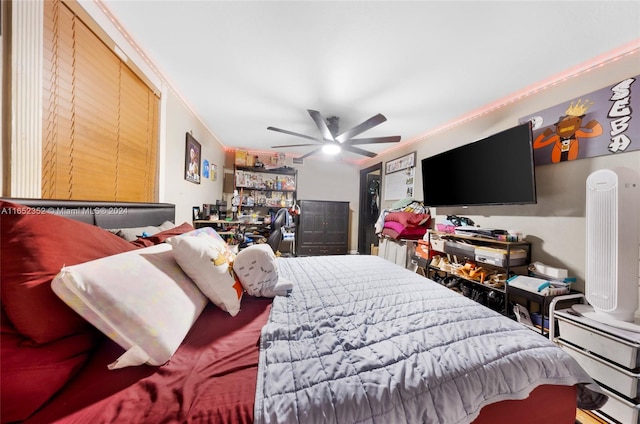 bedroom featuring ceiling fan and crown molding