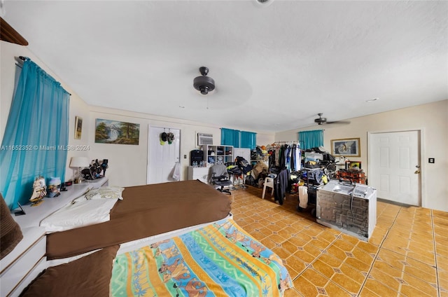 interior space with ceiling fan and an AC wall unit