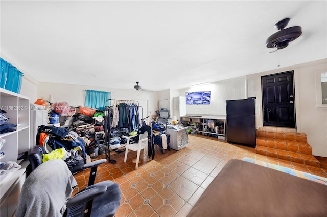 tiled living room with ceiling fan