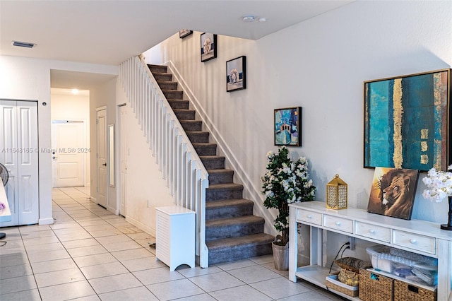 entryway with light tile patterned flooring