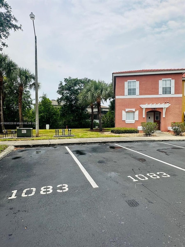 view of car parking featuring a lawn