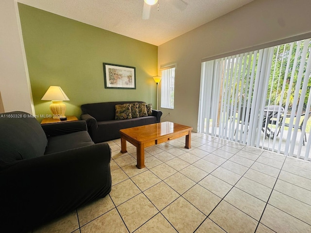 tiled living room featuring a textured ceiling and ceiling fan