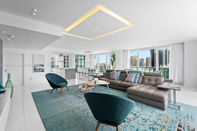 living room featuring light tile patterned floors and a wall of windows