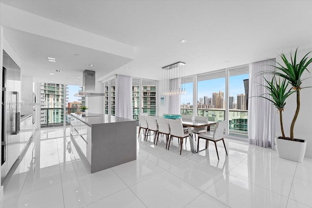 16500 Collins Ave Unit 2451, Sunny Isles Beach, FL 33160 - kitchen with expansive windows, ventilation hood, a view of skyline, light tile patterned floors, and pendant lighting