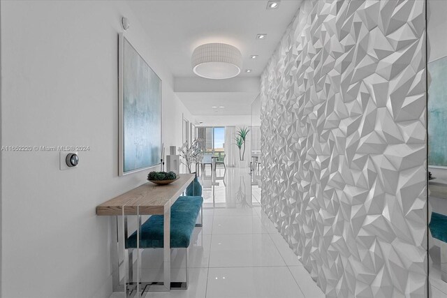 16500 Collins Ave Unit 2451, Sunny Isles Beach, FL 33160 - corridor with an accent wall and tile patterned flooring