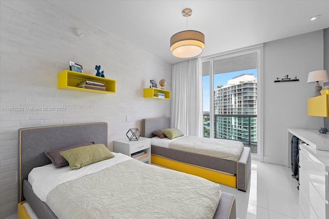 tiled bedroom featuring brick wall