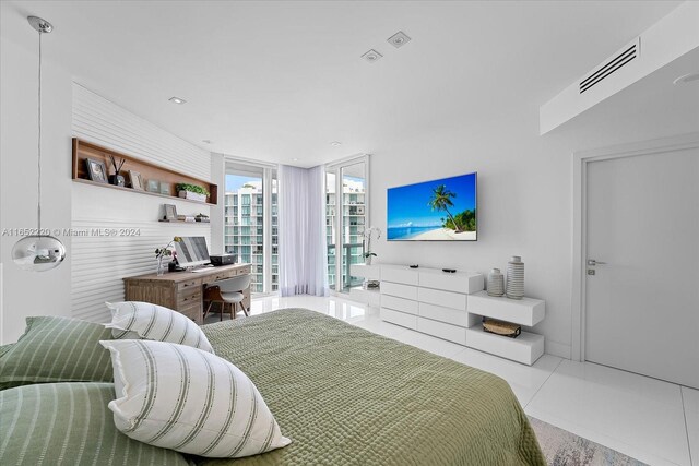 16500 Collins Ave Unit 2451, Sunny Isles Beach, FL 33160 - bedroom featuring tile patterned flooring, a wall of windows, a desk, and recessed lighting