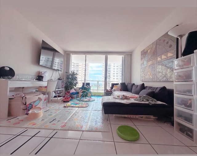 5700 Collins Ave Unit 8B, Miami Beach, FL 33140 - living room featuring tile patterned floors and expansive windows