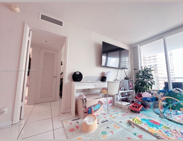 rec room featuring light tile patterned flooring