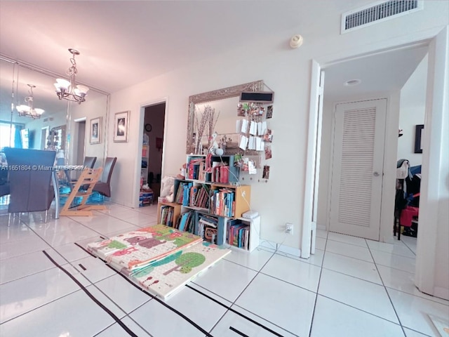 interior space with tile patterned flooring and a notable chandelier