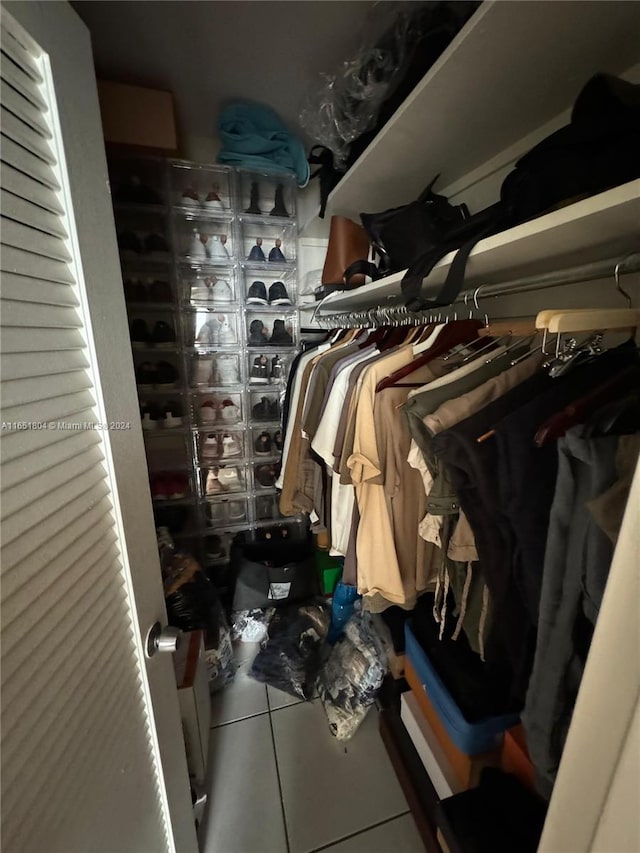5700 Collins Ave Unit 8B, Miami Beach, FL 33140 - walk in closet featuring tile patterned floors