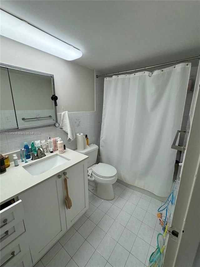 bathroom with walk in shower, tile patterned flooring, vanity, and toilet