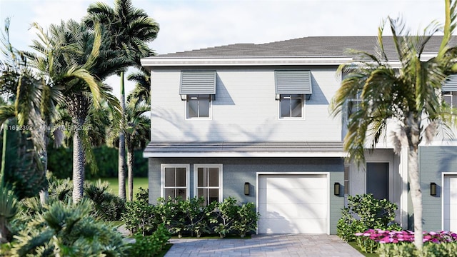 view of front of home featuring decorative driveway and an attached garage