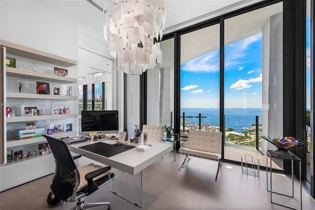 office space with floor to ceiling windows and concrete flooring