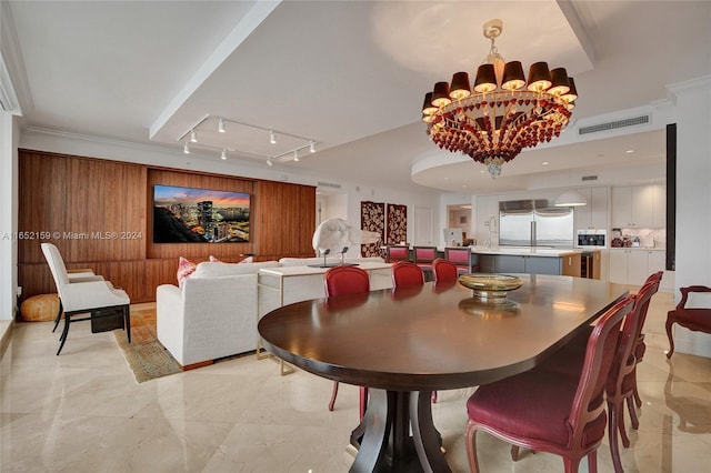 dining area featuring ornamental molding and a chandelier