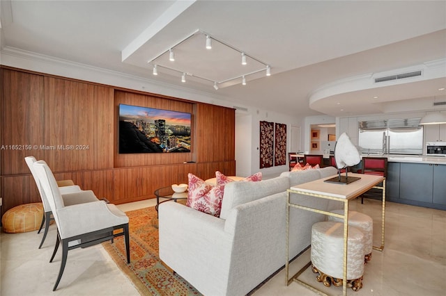 living room featuring wooden walls and ornamental molding