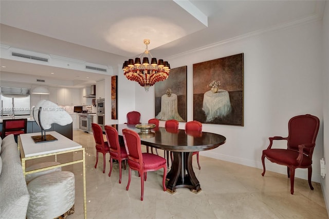 dining room with ornamental molding and a chandelier