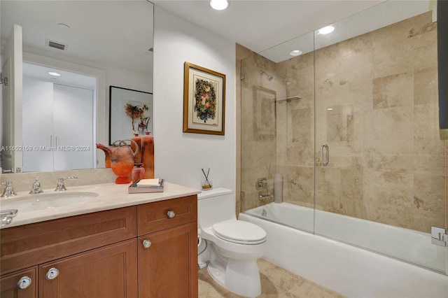 full bathroom featuring enclosed tub / shower combo, vanity, toilet, and tile patterned floors