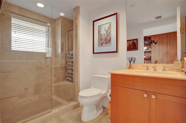 bathroom with vanity, toilet, a shower with door, and tile patterned floors