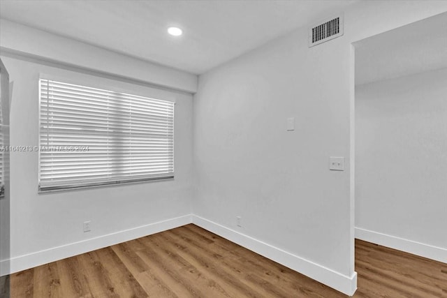 empty room with hardwood / wood-style floors