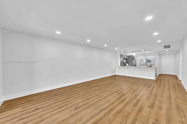 unfurnished living room featuring light hardwood / wood-style floors