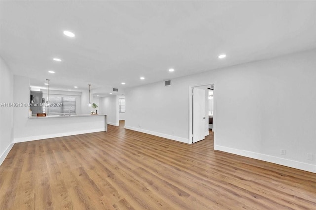 unfurnished living room featuring light hardwood / wood-style floors