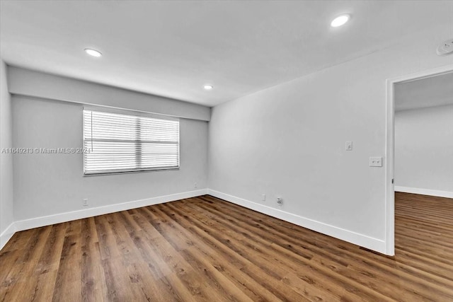 spare room featuring dark hardwood / wood-style flooring