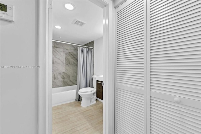 full bathroom featuring shower / tub combo, vanity, and toilet