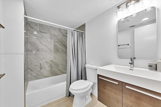 full bathroom with shower / bathtub combination with curtain, vanity, wood-type flooring, and toilet